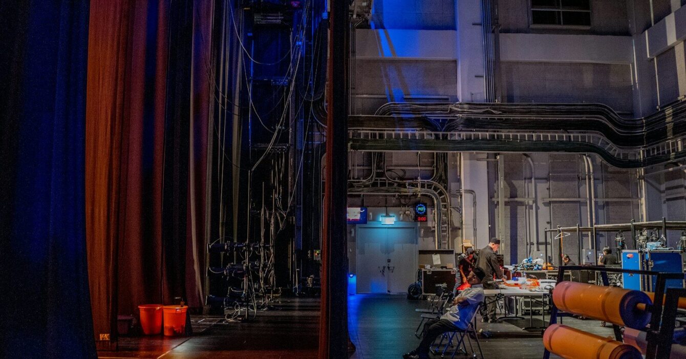 Photo by November Wong a room filled with lots of equipment and a blue curtain