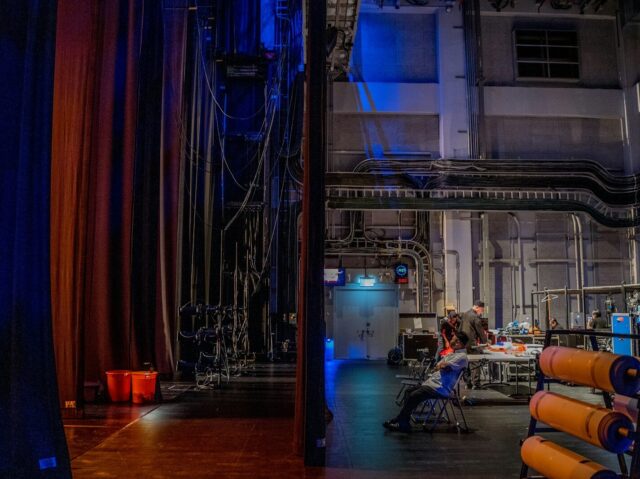 a room filled with lots of equipment and a blue curtain