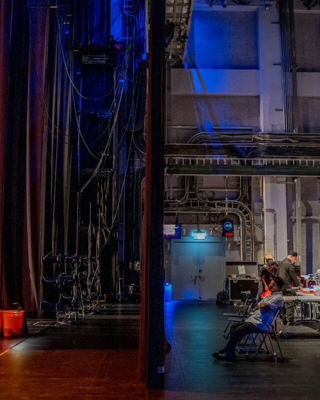 Photo by November Wong a room filled with lots of equipment and a blue curtain