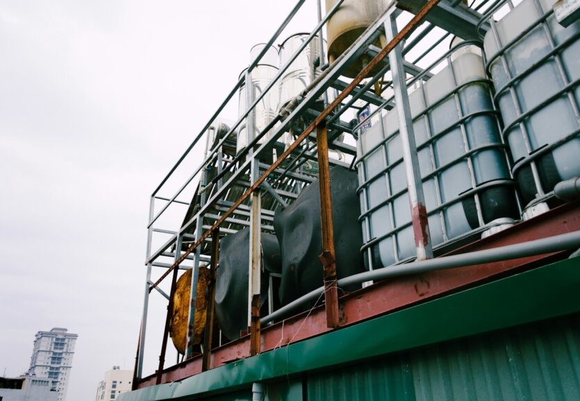 white IBC tanks on green building
