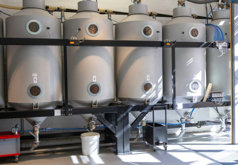 A bunch of tanks are lined up in a room